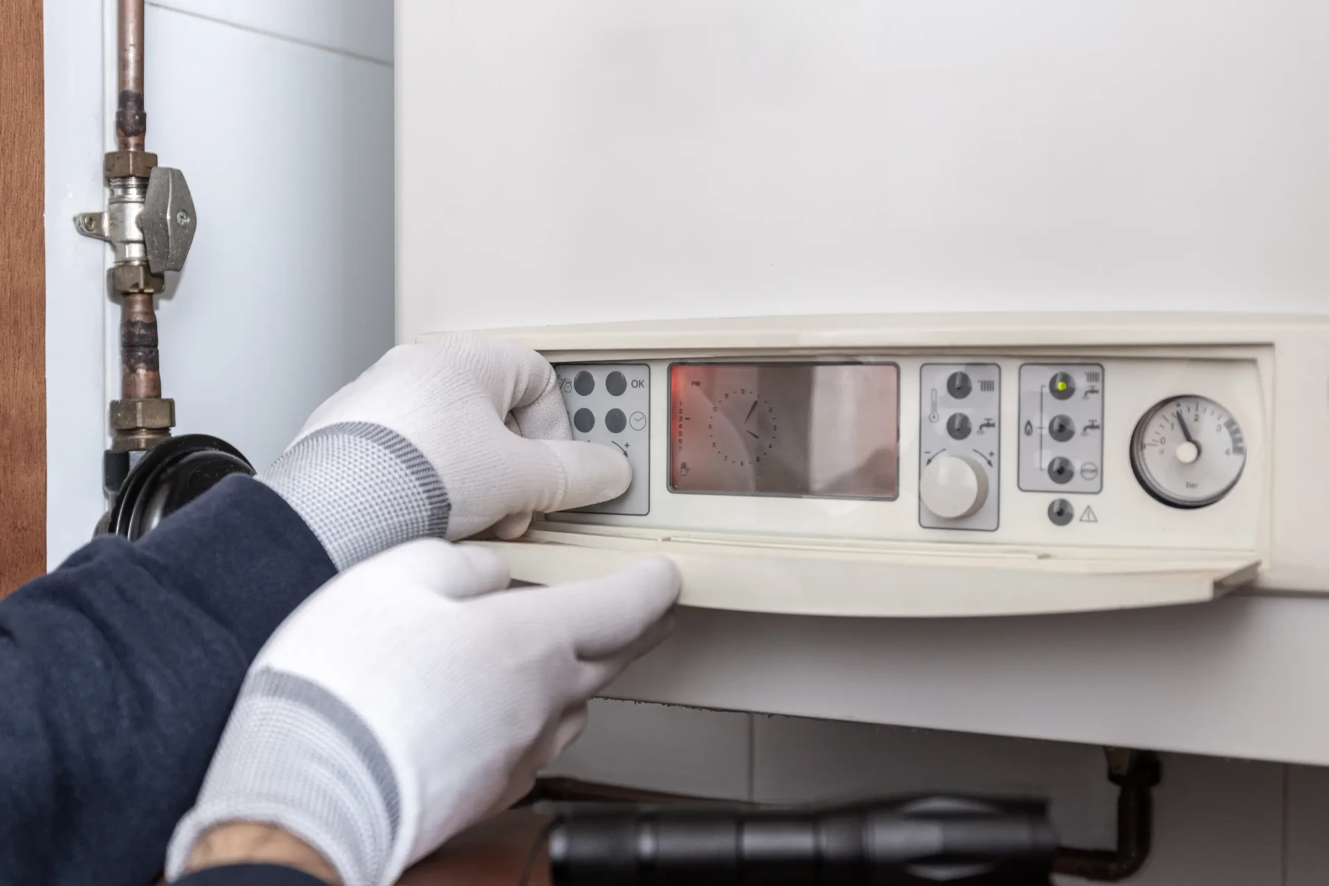 Engineer listening to a noisy boiler during a maintenance visit in Newcastle